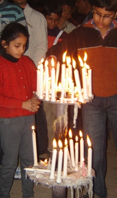 Children Lighting Candles Near Church Entrance